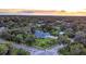 Aerial view of a house nestled in a lush, wooded neighborhood at 1810 S Valrico Rd, Valrico, FL 33596
