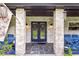 Front porch with blue doors and seating area at 1810 S Valrico Rd, Valrico, FL 33596