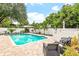 Inviting pool area with patio furniture and lush landscaping at 1810 S Valrico Rd, Valrico, FL 33596
