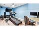 Home gym with treadmill, weights, and monitors at 1810 S Valrico Rd, Valrico, FL 33596