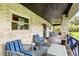 Covered porch with blue and white striped chairs at 1810 S Valrico Rd, Valrico, FL 33596