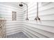 Walk-in shower with horizontal tile and dual shower heads at 1810 S Valrico Rd, Valrico, FL 33596