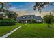 Attractive home exterior, landscaped yard, and walkway at sunset at 1810 S Valrico Rd, Valrico, FL 33596