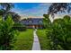 Evening view of charming home with brick pathway and lush lawn at 1810 S Valrico Rd, Valrico, FL 33596