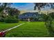 House exterior, showcasing landscaping and brick walkway at dusk at 1810 S Valrico Rd, Valrico, FL 33596