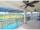 Covered balcony overlooking the pool and lake at 10813 Rolling Moss Rd, Tampa, FL 33647