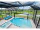 Enclosed pool and spa with lake view at 10813 Rolling Moss Rd, Tampa, FL 33647