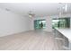 Open living room with access to pool and kitchen at 10813 Rolling Moss Rd, Tampa, FL 33647