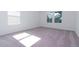 Well-lit bedroom featuring light gray carpet and large windows at 10813 Rolling Moss Rd, Tampa, FL 33647