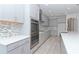 Modern kitchen with stainless steel appliances and gray cabinets at 10813 Rolling Moss Rd, Tampa, FL 33647