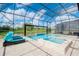 Enclosed pool and spa with lake view at 10813 Rolling Moss Rd, Tampa, FL 33647