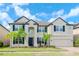 Beautiful two-story house with a three-car garage and lush landscaping at 10813 Rolling Moss Rd, Tampa, FL 33647