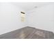 Bright bedroom with grey wood-look flooring and double-door closet at 10813 Rolling Moss Rd, Tampa, FL 33647