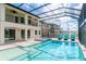Relaxing pool and spa with covered patio and lounge chairs at 10813 Rolling Moss Rd, Tampa, FL 33647