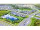 Aerial view of houses and a pond in a residential area at 10813 Rolling Moss Rd, Tampa, FL 33647