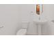 Simple yet elegant bathroom with pedestal sink and toilet at 10813 Rolling Moss Rd, Tampa, FL 33647
