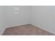 Small bedroom with neutral carpet and a window at 10813 Rolling Moss Rd, Tampa, FL 33647