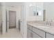 Clean bathroom with granite countertop, gray cabinets, and a double vanity at 10813 Rolling Moss Rd, Tampa, FL 33647