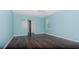 Bedroom with light blue walls and dark wood flooring at 10813 Rolling Moss Rd, Tampa, FL 33647