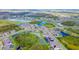 Aerial view of a community with houses, lakes, and lush green landscape at 10813 Rolling Moss Rd, Tampa, FL 33647