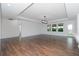 Spacious living room featuring hardwood floors and large windows at 10813 Rolling Moss Rd, Tampa, FL 33647
