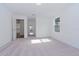 Spacious bedroom with light gray carpet and access to hallway and other rooms at 10813 Rolling Moss Rd, Tampa, FL 33647