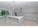 Spacious kitchen island with white quartz countertop, perfect for casual dining at 10813 Rolling Moss Rd, Tampa, FL 33647