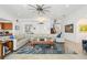 Open concept living room with L-shaped sectional sofa and a large area rug at 833 Ponce De Leon Dr, Tierra Verde, FL 33715