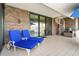 Relaxing patio with blue lounge chairs and a spiral staircase at 833 Ponce De Leon Dr, Tierra Verde, FL 33715