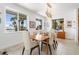 Spacious dining room with water views and modern wood table and chairs at 833 Ponce De Leon Dr, Tierra Verde, FL 33715