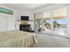Main bedroom features fireplace, water views and sliding door access to balcony at 833 Ponce De Leon Dr, Tierra Verde, FL 33715