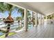 Covered balcony overlooking the marina and pool at 833 Ponce De Leon Dr, Tierra Verde, FL 33715