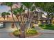 Brick house with three-car garage, palm trees, and circular driveway at 833 Ponce De Leon Dr, Tierra Verde, FL 33715