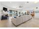 Living room with sectional sofa, fireplace, and kitchen views at 833 Ponce De Leon Dr, Tierra Verde, FL 33715