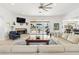 Spacious living room with light colored sectional sofa, fireplace, and water views at 833 Ponce De Leon Dr, Tierra Verde, FL 33715