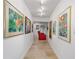 Bright hallway with artwork leading to a home theater at 833 Ponce De Leon Dr, Tierra Verde, FL 33715