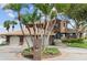 Brick house with three-car garage, palm trees, and circular driveway at 833 Ponce De Leon Dr, Tierra Verde, FL 33715