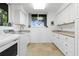 Convenient laundry room with white cabinets and a front load washer and dryer at 833 Ponce De Leon Dr, Tierra Verde, FL 33715