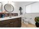 Elegant bathroom with dark wood vanity, marble countertop, and unique decor at 833 Ponce De Leon Dr, Tierra Verde, FL 33715