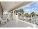 Relaxing balcony overlooking the water with patio furniture at 833 Ponce De Leon Dr, Tierra Verde, FL 33715