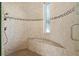 Large walk-in shower with built-in seat and tile detail at 833 Ponce De Leon Dr, Tierra Verde, FL 33715