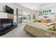Spacious main bedroom with fireplace, water views, and private balcony access at 833 Ponce De Leon Dr, Tierra Verde, FL 33715