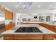 Island kitchen features granite countertops, stainless steel appliances, and wood cabinets at 833 Ponce De Leon Dr, Tierra Verde, FL 33715