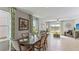 Elegant dining room with a dark wood table, neutral decor and adjacent living area at 7203 Broad River Ave, Land O Lakes, FL 34638