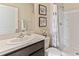 Clean bathroom with a single sink vanity, shower/tub combo, and neutral decor at 7203 Broad River Ave, Land O Lakes, FL 34638