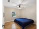 Spacious bedroom with wood floors and large window at 9913 Alavista Dr, Gibsonton, FL 33534