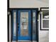 Modern blue front door with sidelights and elegant glass at 9913 Alavista Dr, Gibsonton, FL 33534