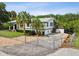 Single story home with a gravel driveway and fenced yard at 9913 Alavista Dr, Gibsonton, FL 33534