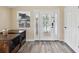Bright entryway with wood-look floors and a glass-paned door at 9913 Alavista Dr, Gibsonton, FL 33534