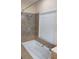 Bathroom with soaking tub, shower, and window at 9913 Alavista Dr, Gibsonton, FL 33534